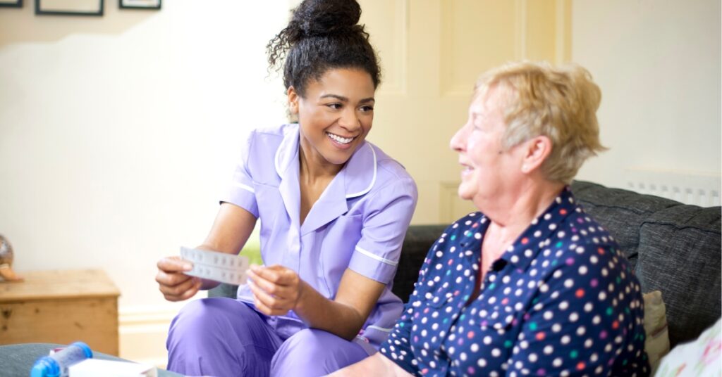 Carer chats with patient while dispensing medication